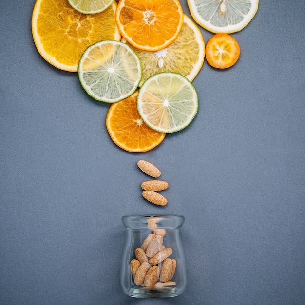 Healthy foods and medicine concept.  Mixed citrus fruits sliced on gray background flat lay.