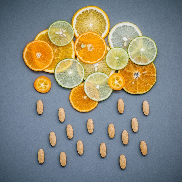 Healthy foods and medicine concept.  Mixed citrus fruits sliced on gray background flat lay.