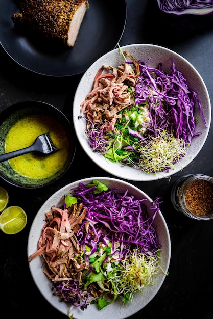 Healthy fresh cabbage salad with roasted meat lime juice sauce greens lettuce Black kitchen