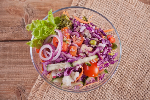 Healthy fresh salad in bowl with vegetables. Top view.