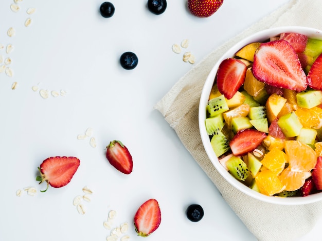 Healthy fruit and berry salad on table