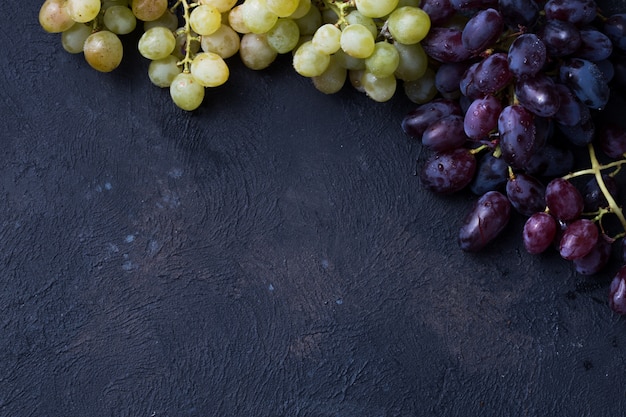 Healthy fruits Red and White wine grapes on stone surface s .