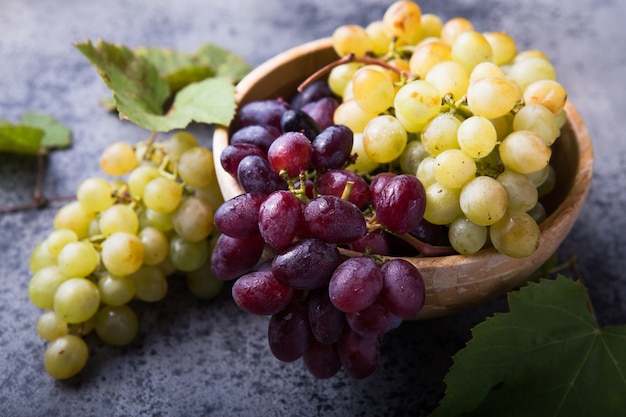 Healthy fruits Red and White wine grapes on stone surface s