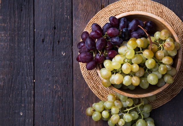 Healthy fruits Red and White wine grapes on wooden surface s