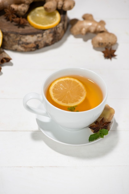 Healthy ginger tea ingredients on a wooden table