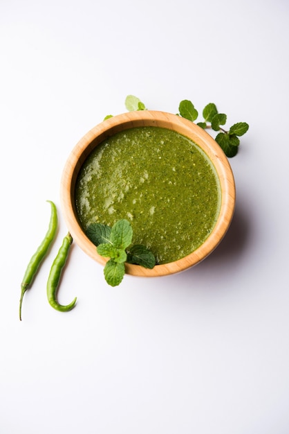 Healthy Green Mint Chutney Made with Coriander, pudina And Spices. isolated moody background. selective focus