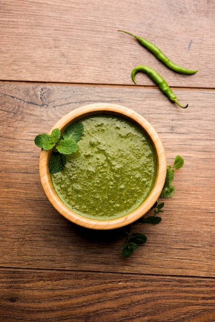 Healthy Green Mint Chutney Made with Coriander, pudina And Spices. isolated moody background. selective focus