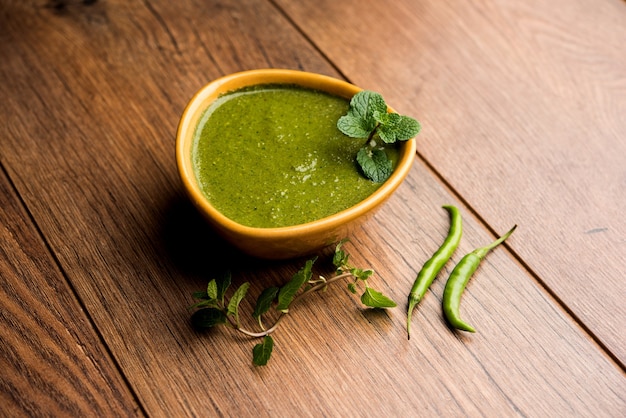 Healthy Green Mint Chutney Made with Coriander, pudina And Spices. isolated moody background. selective focus