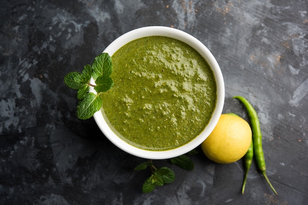 Healthy Green Mint Chutney Made with Coriander, pudina And Spices. isolated moody background. selective focus