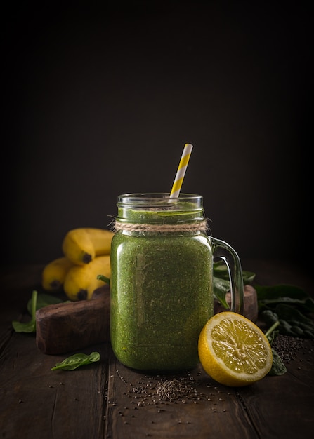 Healthy green smoothie with spinach in glass jar