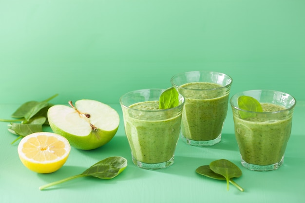 Healthy green smoothie with spinach leaves apple lemon