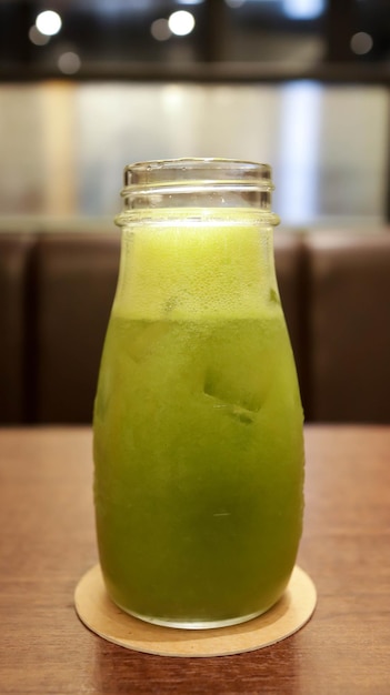 Healthy green vegetable juice in a glass bottle