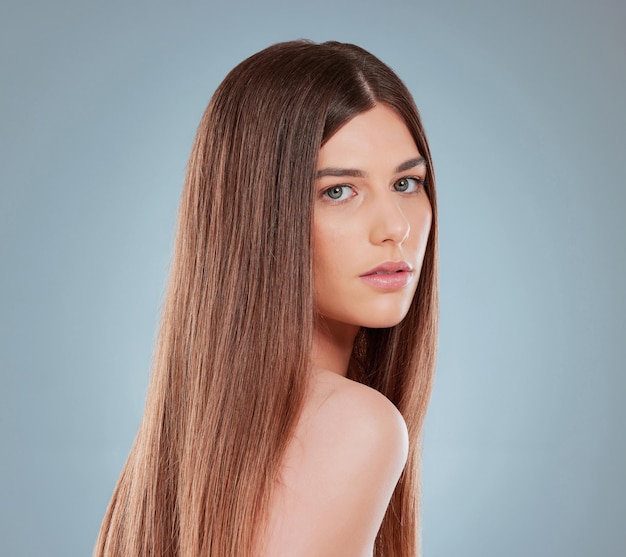 Healthy hair is a sign of good health. Studio shot of a beautiful young woman showing off her long brown hair.