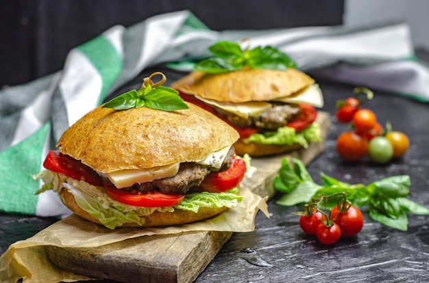 Healthy homemade burger with beef, tomatoes, cheese and basil