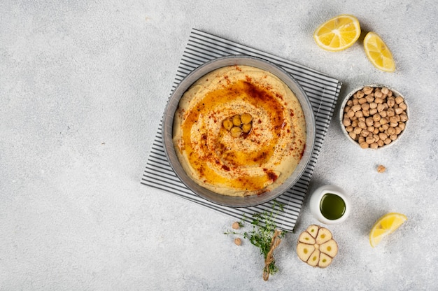 Healthy Homemade Creamy Hummus with Olive Oil and paprika. Top view of food. Mediterranean food. Healthy snack. Vegetarian hummus.