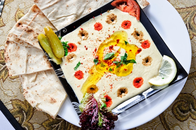 Healthy Homemade Creamy Hummus with Olive Oil and Pita Chips.