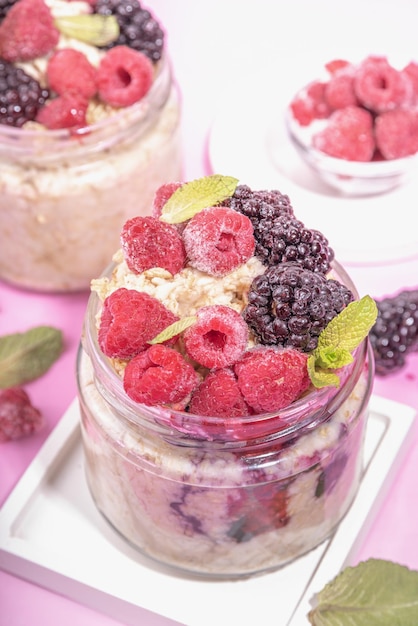 Healthy Homemade Overnight Oats Oatmeal with berry Portioned Oatmeal with fresh raspberry ans blackberry in a glass jar Healthy summer breakfast