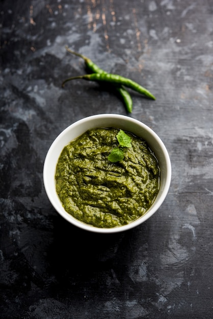 Healthy Indian Green Chutney or Sauce Made using Coriander, Mint And Spices. isolated over moody background. Selective focus