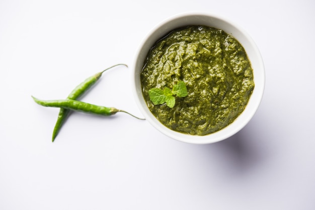 Healthy Indian Green Chutney or Sauce Made using Coriander, Mint And Spices. isolated over moody background. Selective focus