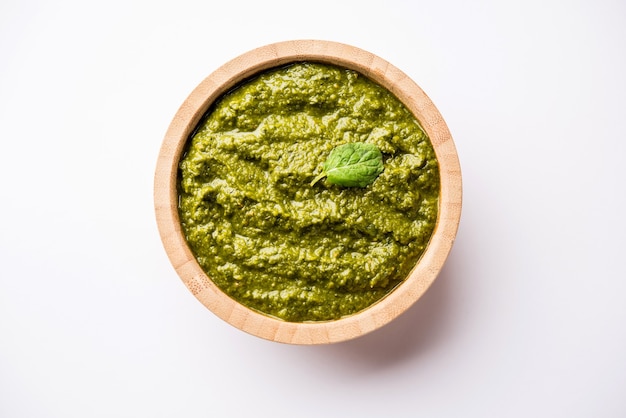 Healthy Indian Green Chutney or Sauce Made using Coriander, Mint And Spices. isolated over moody background. Selective focus