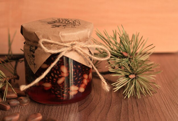 Healthy jam from pine cones with pine nuts on a beige background