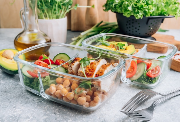 Healthy lunch in glass containers on light gray table. .