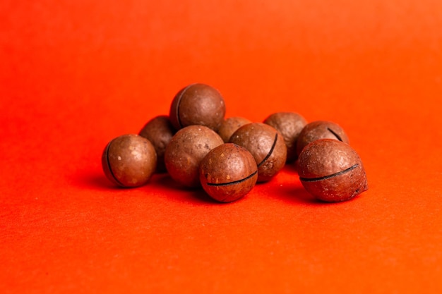 healthy macadamia nut for health on a red background