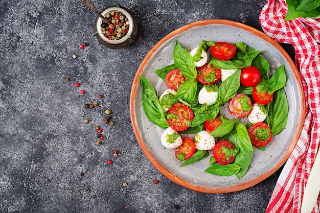 Healthy meal with cherry tomatoes, mozzarella balls and basil.