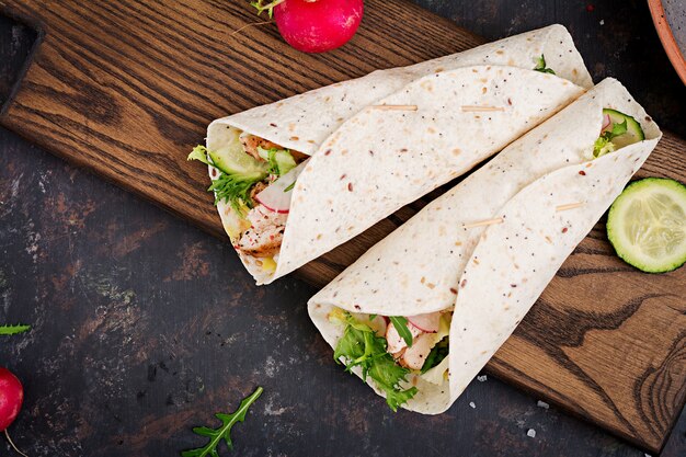 Healthy mexican tacos with baked chicken breast, cucumber, radish and lettuce. 