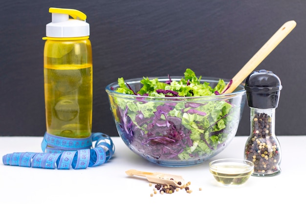 A healthy natural fresh salad of purple cabbage and lettuce. Diet, vegetarianism. Measuring tape on the table.