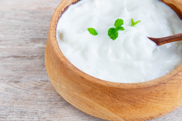 Healthy natural yoghurt on a wooden table