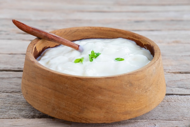 Healthy natural yoghurt on a wooden table