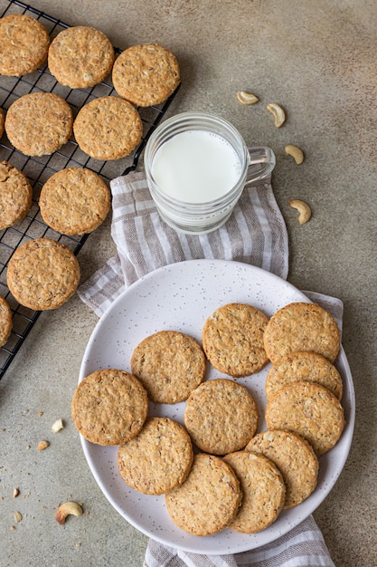 Healthy oatmeal cookies with cereals, seeds and nuts with a cup of milk