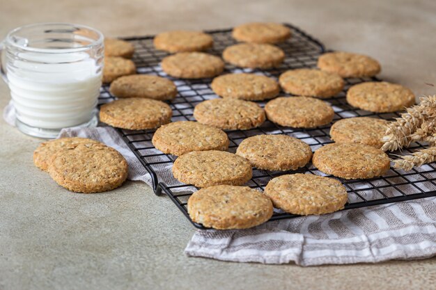 Healthy oatmeal cookies with cereals, seeds and nuts with a cup of milk