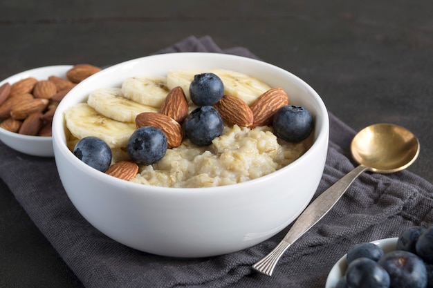 Healthy oatmeal porridge for Breakfast. with nuts, blueberries and banana.