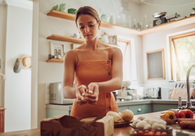 Healthy organic and fresh food and vegetables ready for cooking with a young woman in a kitchen Female nutritionist ready to make a nutrition weight loss and health diet meal for dinner at home