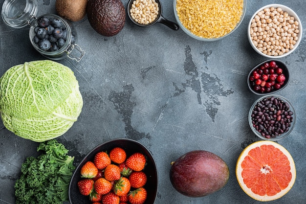 Healthy products frame or border concept, flat lay, on grey table.