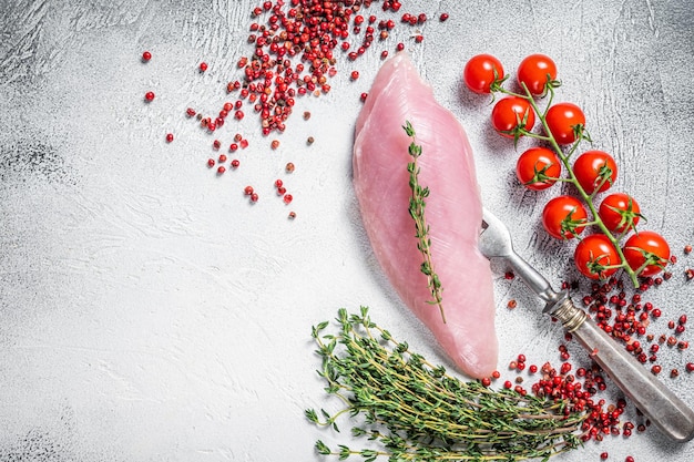 Healthy protein diet with Turkey raw breast fillet steaks and herbs White background Top view Copy space