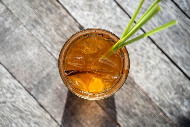 Healthy refreshing drink of cinnamon and stalks of lemongrass on a wooden table top view