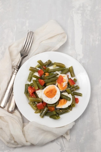 Healthy salad green beans pepper and boiled eggs on plate