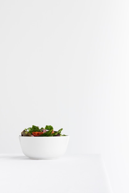 Healthy salad in white bowl assortment with copy space