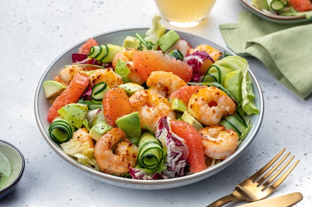 Healthy salad with shrimp prawns grapefruit avocado cucumber and green salad