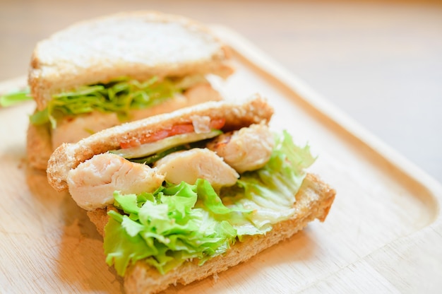 Healthy sandwich with whole grain bread, tomato, lettuce,  onion, pepper and chicken.