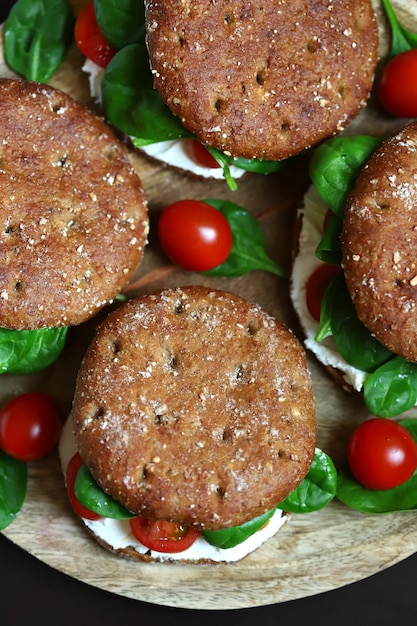 Healthy sandwiches with Philadelphia cheese spinach and cherry tomatoes with rye buns