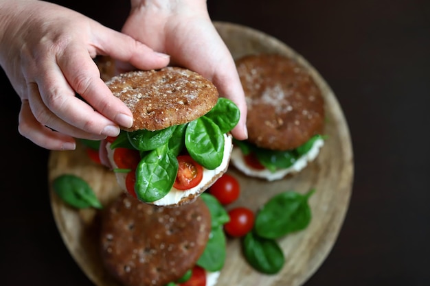 Healthy sandwiches with spinach cherry tomatoes and white cheese Useful snack Keto diet