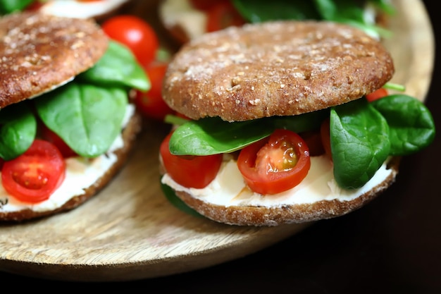 Healthy sandwiches with spinach cherry tomatoes and white cheese Useful snack Keto diet