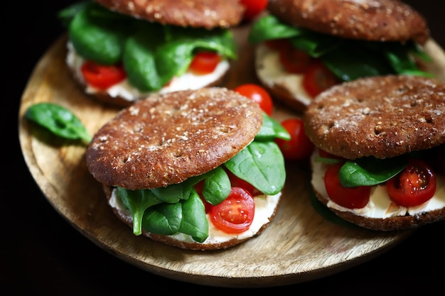 Healthy sandwiches with spinach cherry tomatoes and white cheese Useful snack Keto diet