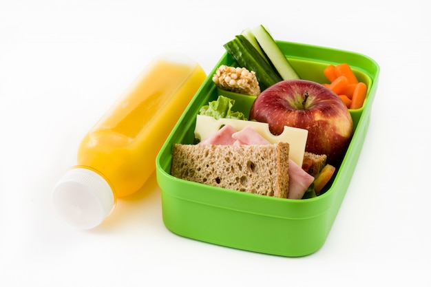 Healthy school lunch with Sandwich, vegetables ,fruit and juice isolated on white