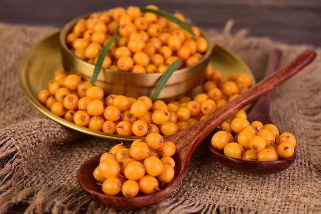 Healthy sea buckthorn berries on a dark backgroundCloseup