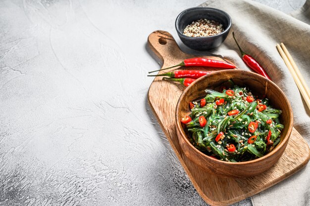 Healthy seaweed chuka salad with greens and red chili pepper. Top view. Copy space